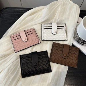 Woven texture credit card holder in pink, white, and black with snap fastener closure