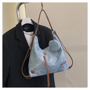 Hobo tote bag in washed blue texture with brown strap and small circular coin pouch