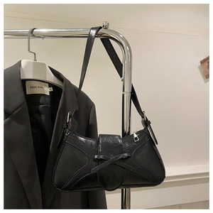 Détail du sac sous l'aisselle en cuir PU noir avec un nœud délicat et une texture lisse