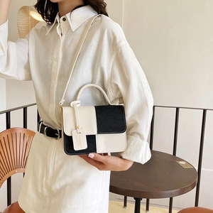 Modern black and white patchwork tote bag with top handle and adjustable shoulder strap