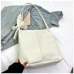 Detailed view of white marble texture handbag with an elegant lace bow decoration