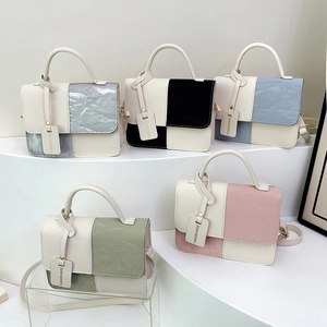 Minimalist patchwork crossbody square bags in five trendy colors on white podium