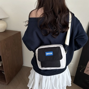 Minimalist canvas color-block crossbody bag for students shown on a model