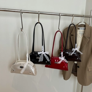 Chic patent leather shoulder bag with white lace bow and elegant glossy finish