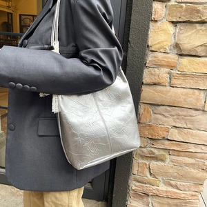 Silver metallic large tote bag with white lace trim and minimalist wrinkled texture finish