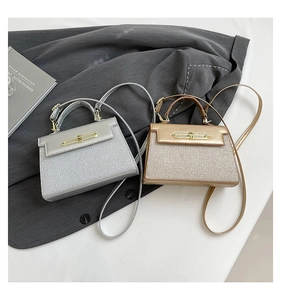 Detail of silver and champagne gold glitter top handle bags with long metal buckle