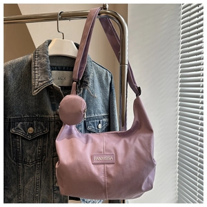 Détail du sac bandoulière en nylon lavande avec petit sac rond et logo en lettres