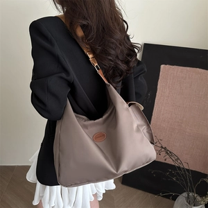 Minimalist mocha nylon dumpling bag with adjustable shoulder strap and large capacity