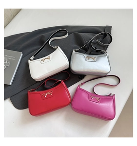 Detail view of four baguette bags in white, silver, red and pink with gold bow buckle