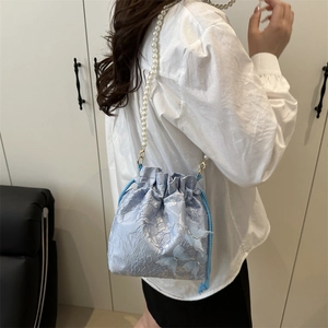 Light blue pleated bucket bag with pearl strap and 3D butterfly floral textures