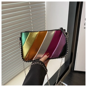 Detailed shot of rainbow patchwork leather crossbody bag with silver chain and studs