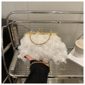 Detail of white 3D floral evening bag with gold ball clasp and metallic chain strap