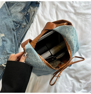 Top view of denim bucket bag interior showing capacity for tablet and cosmetics