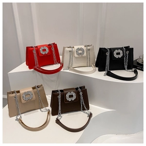 Close-up of five colorful crossbody bags with crystal square buckles and chain straps