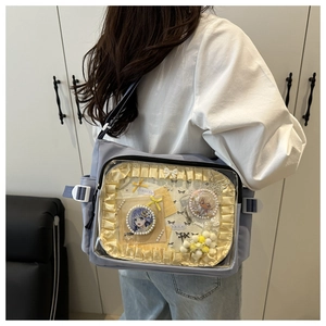 Vue détaillée d'un sac ita avec fenêtre transparente affichant des badges anime