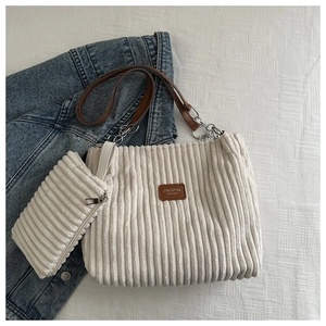 Detail of corduroy tote bag and mini pouch set with chain strap and leather patch