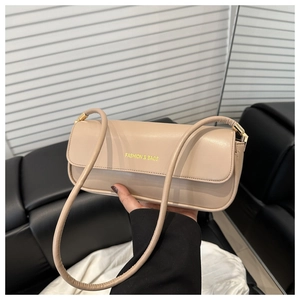 Close-up of beige leather baguette bag with Fashion & Bags logo and slender strap