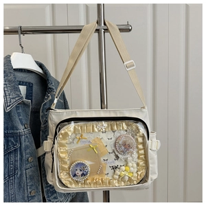 Détail du sac ita en toile blanche avec poche PVC transparente et badges d'anime
