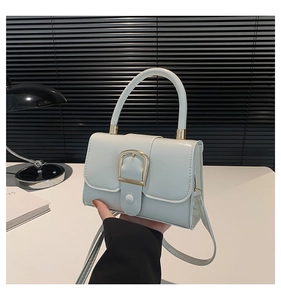Dettaglio borsa a mano vintage azzurra in pelle oliata con fibbia dorata e manico