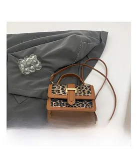 Detail of vintage leopard print mini square bag with leather panel and gold buckle