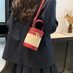 Leopard cylindrical bucket bag in red and white weave with adjustable strap