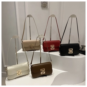 Detail view of five luxury leather flap bags with large gold interlocking geometric buckles