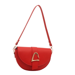 Minimalist red saddle shoulder bag with golden geometric buckle on plain white background