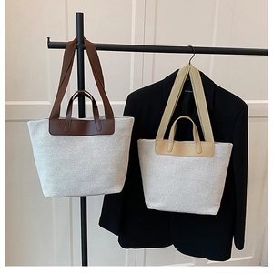 Dual-handle canvas tote bags showing reinforced straps and minimalist color contrast design
