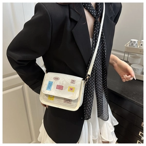 Detailed shot of white marble patterned crossbody bag with colorful artistic patches