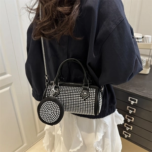 Black rhinestone cylinder handbag with chain strap and matching coin purse on model