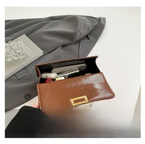 Interior view of brown leather crossbody bag showing capacity for phone and makeup