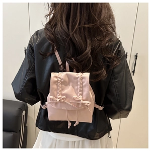 Detailansicht der Rückseite eines rosa Mini-Rucksacks mit Rüschen und Schleifen für den Alltag