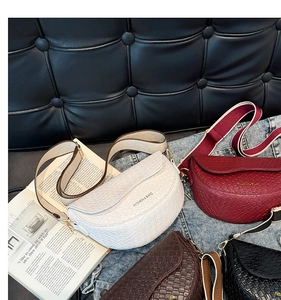 Detail of woven textured saddle bags in multiple colors with adjustable wide straps