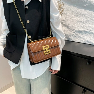 Brown quilted oil wax leather crossbody bag with gold chain strap and metal clasp closure