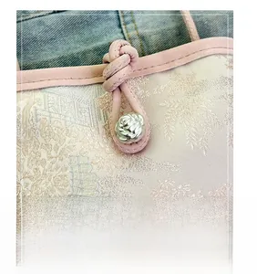 Detail of pink jacquard fabric with traditional Chinese knot buckle and silver rose metal button
