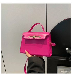 Detail of rose pink mini trapezoid bag with single handle and gold metal twist lock
