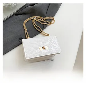 Comparison of a white crocodile embossed handbag with a smartphone showing its actual size