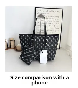 Black printed large tote bag set with matching small pouch and mobile phone for scale
