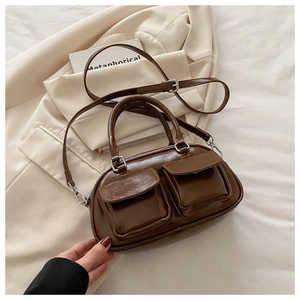 Detail of coffee brown retro faux leather pillow bag with double front flap pockets