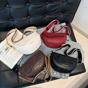 Large woven leather saddle bag with broad fabric strap in four minimalist colors