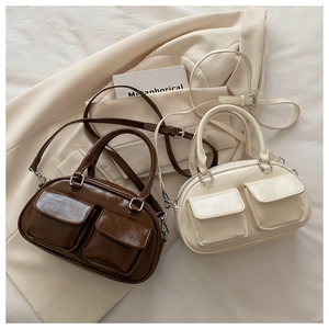 Chic semi-elliptical pillow bag with dual front flap pockets and adjustable strap