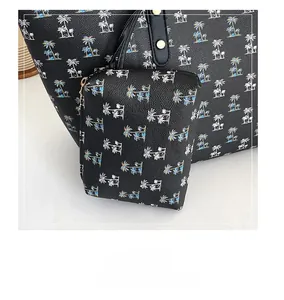 Detail of black tote bag set with colorful palm tree prints and matching small pouch