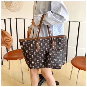 Detailed view of canvas tote bag set with palm tree prints and brown shoulder straps