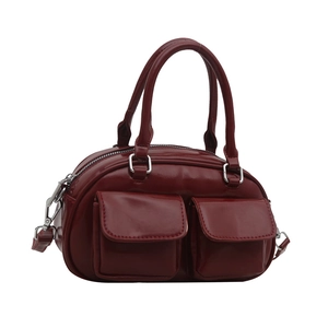 Deep red Boston style faux leather handbag with twin front flap pockets and round handles