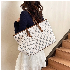Detail view of the tropical coconut tree print canvas tote set with brown leather straps