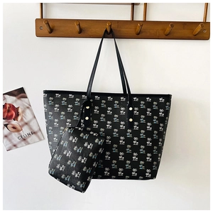 Detailed view of black two-piece tote bag set featuring white and blue coconut tree prints