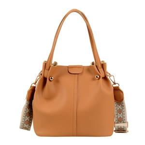 Caramel leather bucket bag with bohemian strap and gold rivets on a white background