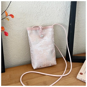 Detailed embroidery of traditional landscape scenery on pink silk phone crossbody bag