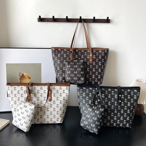 Three large printed tote bags with palm tree patterns and matching small pouches in various colors