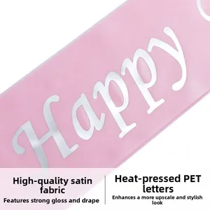 Detail of pink satin sash showing premium fabric texture and white PET foil lettering